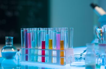 close-up of colorful medical tubes placed in a plastic rack, in a laboratory